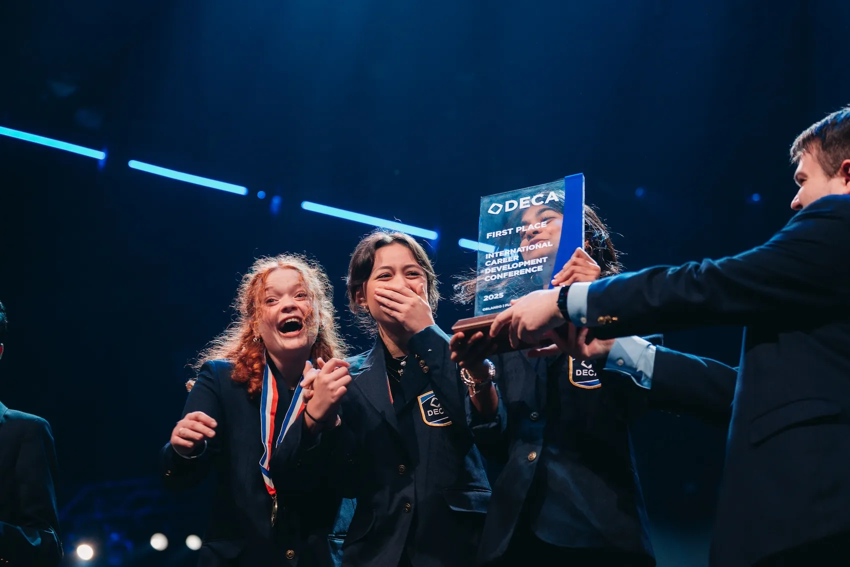 CEO Alex Mellott awards the 1st place trophy to the winners of DECA's Independent Business Plan competitive event at the 2025 International Career Development Conference