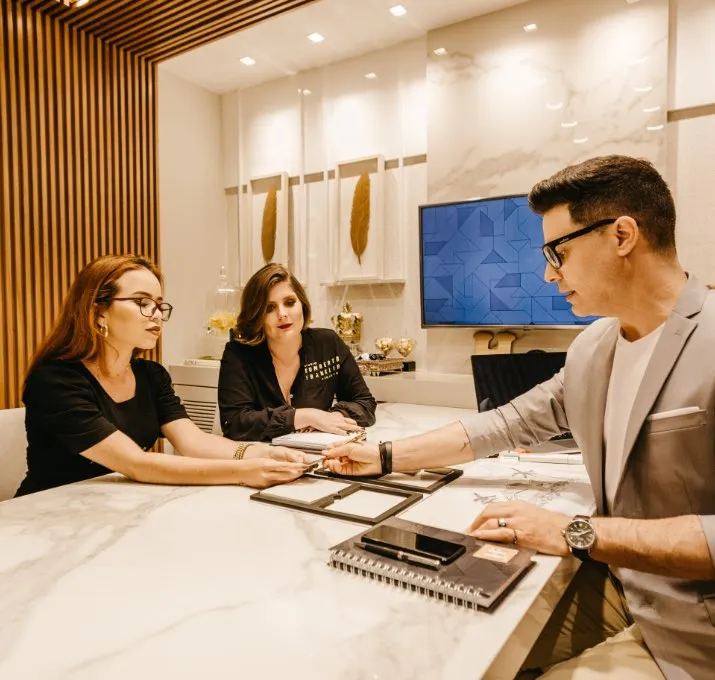 Three people at a table having a discussion