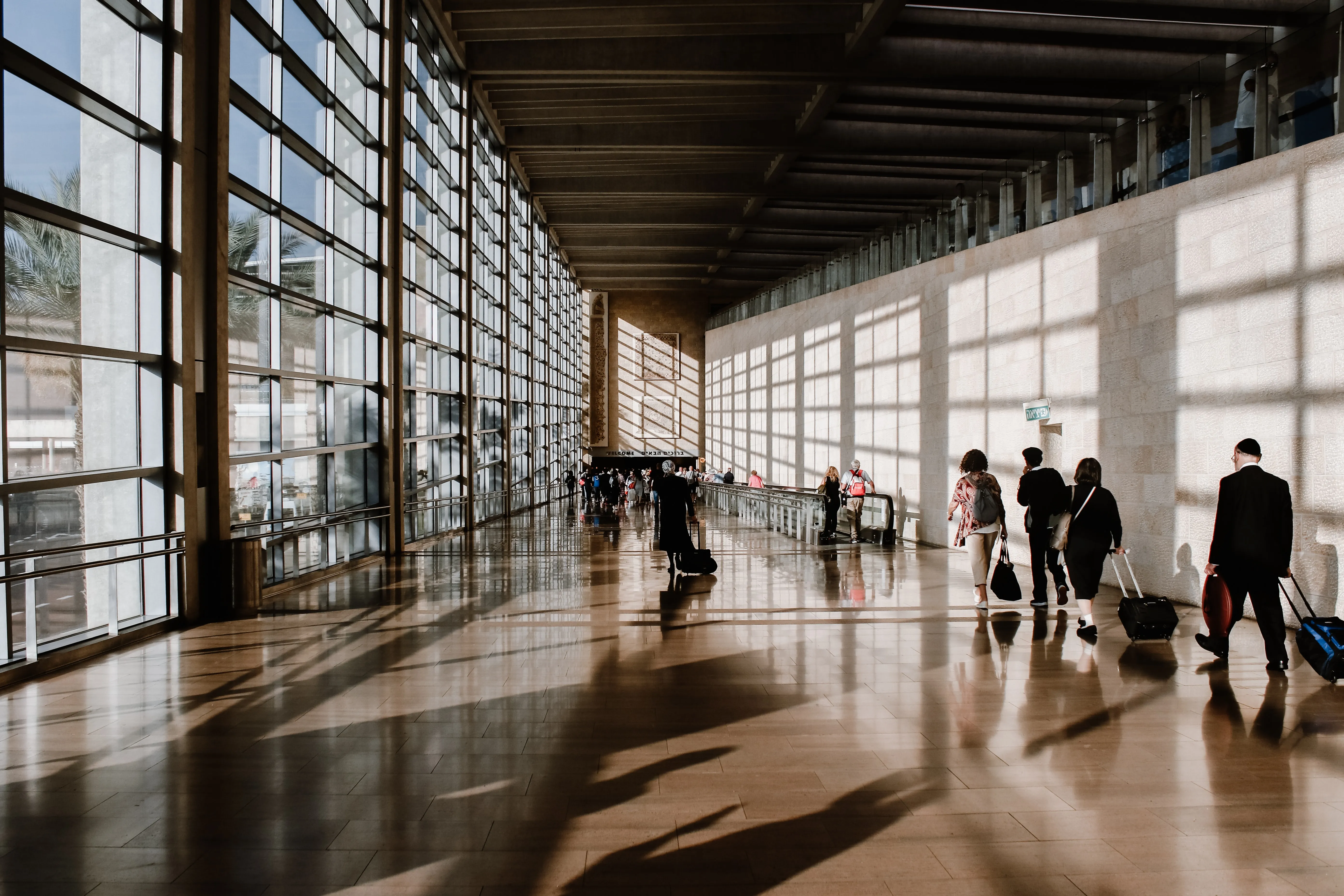 Business traveler smiling while walking through an airport terminal